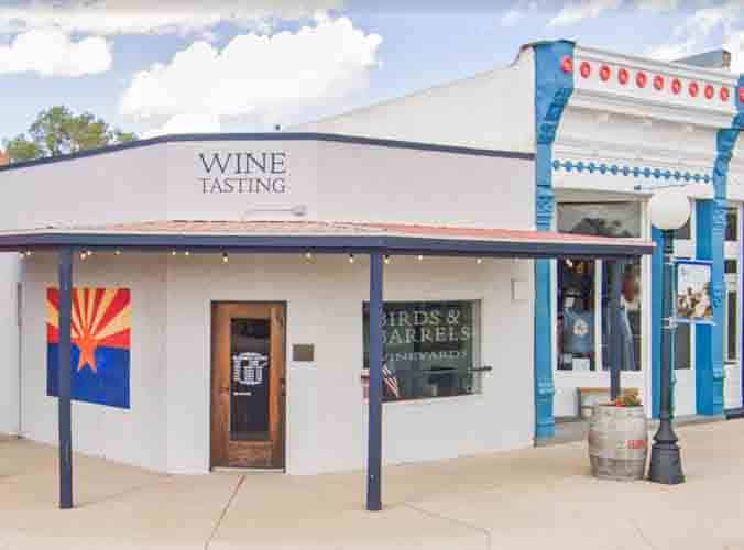 The entrance to a winery tasting room in downtown Willcox, Arizona. A window sign says "Birds and Barrels Vineyards," which is among the best wineries in Willcox, Arizona.